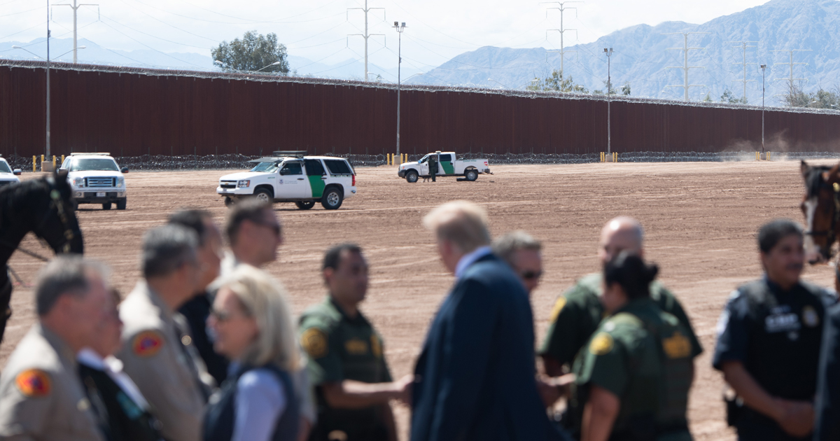 US President Donald Trump speaks with members of the US Customs and Border Patrol as he tours the border wall between the United States and Mexico in Calexico, California on April 5, 2019.