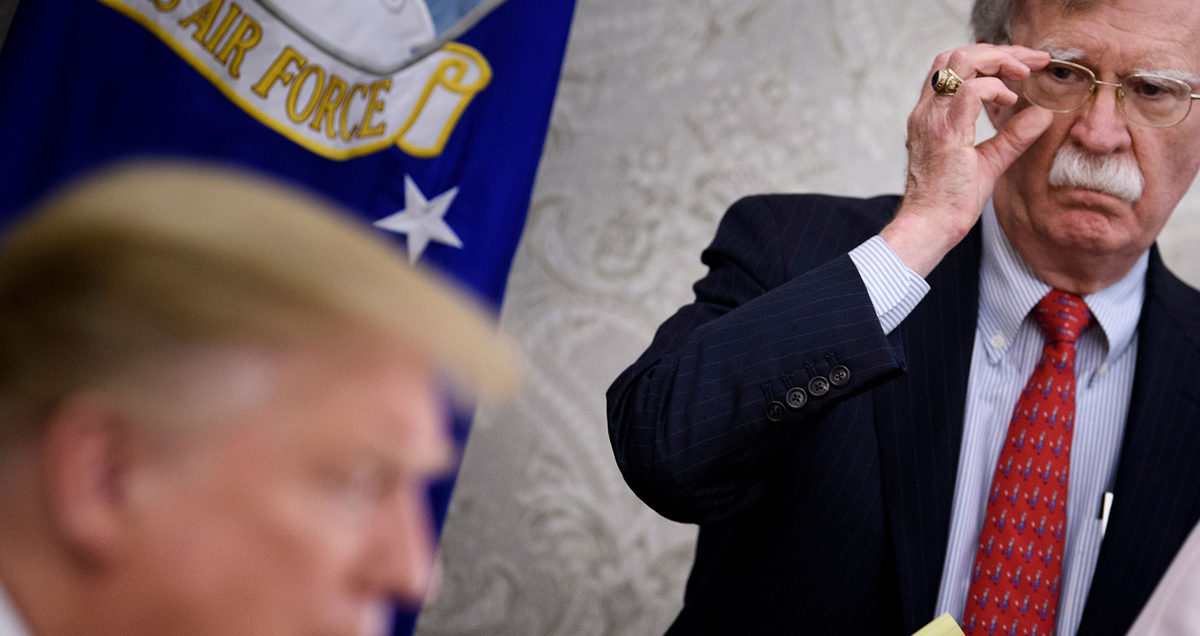 National Security Advisor John R. Bolton listens while US President Donald Trump speaks to the press before a meeting with Hungary's Prime Minister Viktor Orban in the Oval Office of the White House on May 13, 2019, in Washington, DC.