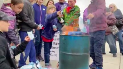 Twitter Aghast Over Parents, Children Burning Masks in Protest
