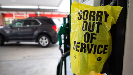 An Out Of Service bag covers a gas pump as cars continue line up for the chance to fill their gas tanks at a Circle K near uptown Charlotte, North Carolina on May 11, 2021 following a ransomware attack that shut down the Colonial Pipeline.