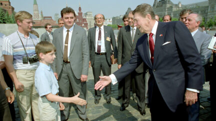 Ronald Reagan shakes hand with young boy in Red Square, Moscow