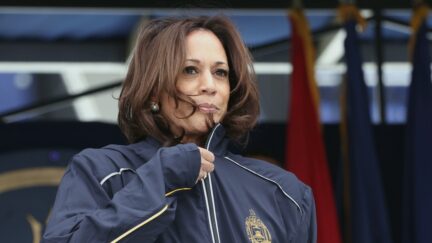 ANNAPOLIS, MARYLAND - MAY 28: U.S. Vice President Kamla Harris puts on a U.S. Navy jacket given to her by the class of 2021 as she delivers remarks at the U.S. Naval Academy Graduation and Commissioning Ceremony at the Naval Academy on May 28, 2021 in Annapolis, Maryland. The graduating class of 1,084 will be commissioned as ensigns in the Navy or second lieutenants in the Marine Corps. (Photo by Kevin Dietsch/Getty Images)