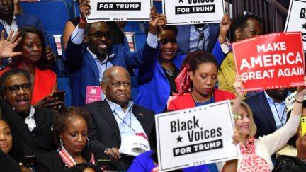 Herman Cain (C,L) and supporters of US President Donald Trump