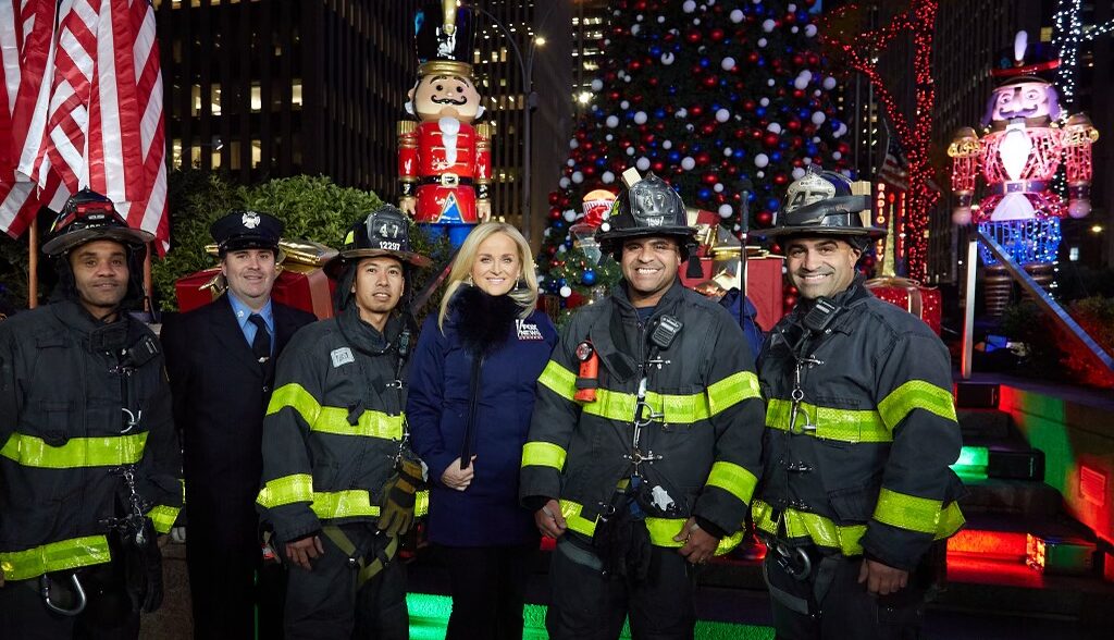 Suzanne Scott with FDNY firefighters at lighting of Christmas tree