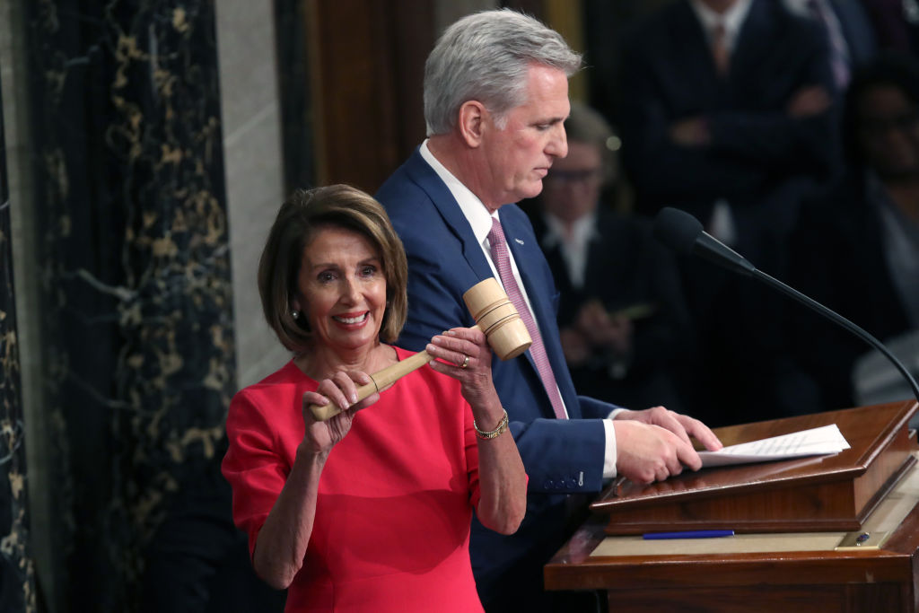 nancy pelosi smiling with beak and kevin McCarthy in background january 2019