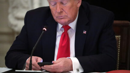 Trump holding a phone