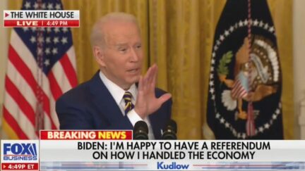 Joe Biden holding up hand at presser