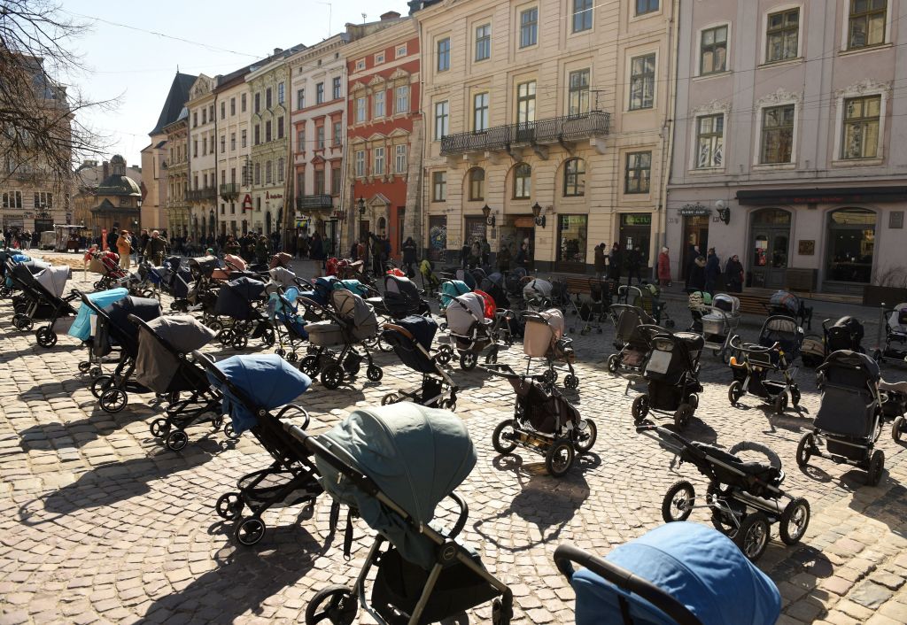 strollers and car seats in Lviv, Ukraine memorializing children killed by Russian attacks