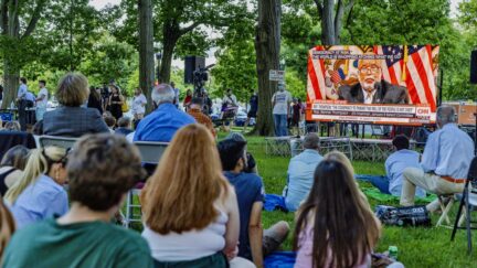 WASHINGTON, DC - JUNE 09: People gather to watch the hearing of the Select Committee to Investigate the January 6th Attack on the U.S. Capitol on June 09, 2022 in Washington, DC. The bipartisan committee, which has been gathering evidence related to the January 6th attack at the U.S. Capitol for almost a year, will present its findings in a series of televised hearings. On January 6th, 2021, supporters of President Donald Trump attacked the U.S. Capitol Building in an attempt to disrupt a congressional vote to confirm the electoral college win for Joe Biden. (Photo by Tasos Katopodis/Getty Images)