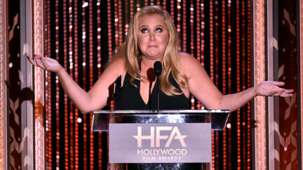 amy schumer with her arms raised looking puzzled