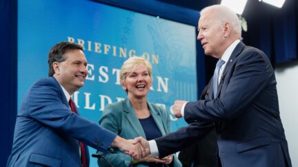 US President Joe Biden shakes hands with White House Chief of Staff Ron Klain (L) alongside Secretary of Energy Jennifer Granholm (C) as he arrives for a briefing on wildfires ahead of the wildfire season with cabinet members, government officials, as well as governors of several western states, in the Eisenhower Executive Office Building in Washington, DC, June 30, 2021. (Photo by SAUL LOEB / AFP) (Photo by SAUL LOEB/AFP via Getty Images)