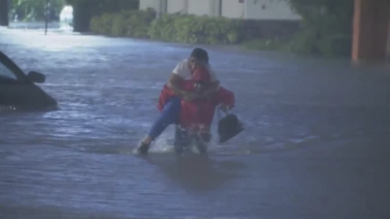 WATCH: Reporter Carries Woman from Flood Waters as Hurricane Ian Descends on Orlando