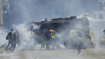 Brazil protesters attacking police armored vehicle