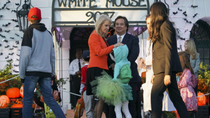 Counselor to the President Kellyanne Conway, center, and her husband George Conway, right, greet guests on the South Lawn of the White House in Washington during a Halloween event welcoming children from the Washington area and children of military families to trick-or-treat, Monday, Oct. 30, 2017.