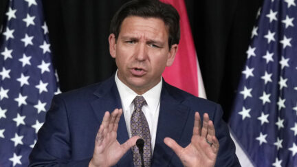 Florida governor Ron DeSantis with his hands up