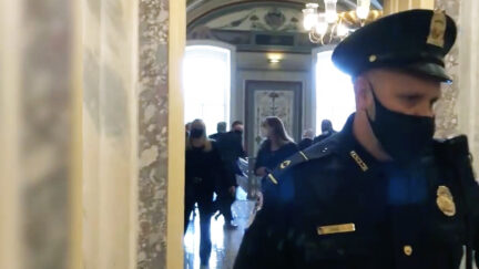 Capitol Police officer shown guarding a hallway as Sen. Chuck Grassley is evacuated on January 6, 2021