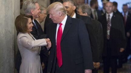 Nancy Pelosi shaking hands with Donald Trump