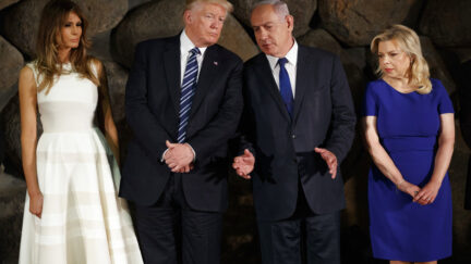 President Donald Trump talks with Israeli Prime Minister Benjamin Netanyahu during a ceremony to lay a wreath at Yad Vashem to honor the victims of the holocaust, Tuesday, May 23, 2017, in Jerusalem. From left, first lady Melania Trump, Trump, Netanyahu, and Sara Netanyahu.