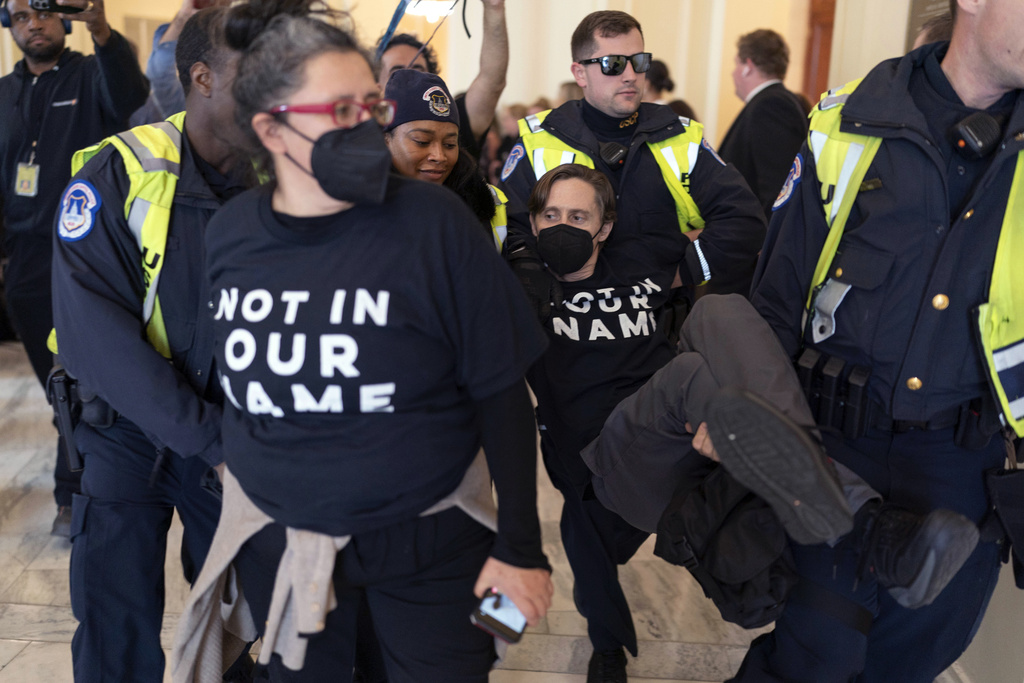 U.S. Capitol Police officers detain a demonstrator protesting inside the Cannon House Office Building on Capitol Hill in Washington, Wednesday, Oct. 18, 2023. 