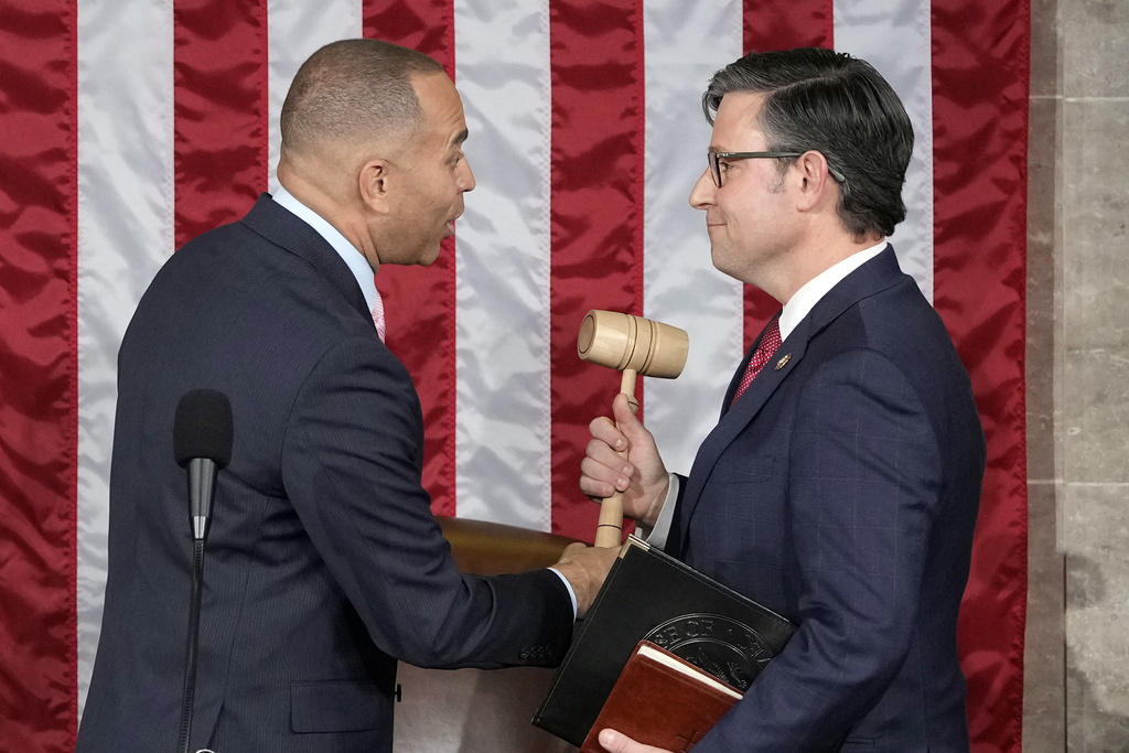 House Minority Leader Hakeem Jeffries of N.Y., hands the gavel to speaker-elect Rep. Mike Johnson, R-La., at the Capitol in Washington, Wednesday, Oct. 25, 2023.