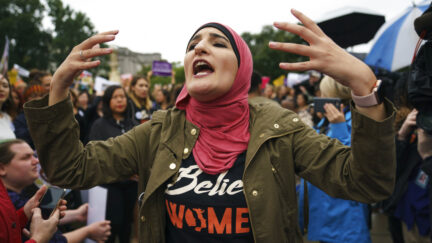 Linda Sarsour with Women's March calls out to other activists opposed to President Donald Trump's embattled Supreme Court nominee, Brett Kavanaugh, in front of the Supreme Court on Capitol Hill in Washington, Monday, Sept. 24, 2018. A second allegation of sexual misconduct has emerged against Judge Brett Kavanaugh, a development that has further imperiled his nomination to the Supreme Court, forced the White House and Senate Republicans onto the defensive and fueled calls from Democrats to postpone further action on his confirmation. President Donald Trump is so far standing by his nominee.