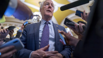 Sen. John Cornyn, R-Texas, is surrounded by reporters as he heads to the chamber during a test vote to begin debate on a border security bill, at the Capitol in Washington, Wednesday, Feb. 7, 2024.