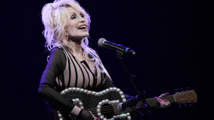 Dolly Parton singing and playing guitar