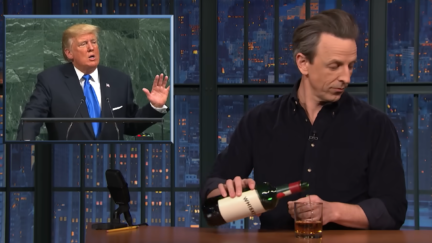 Seth Meyers makes himself a drink next to an image of Donald Trump