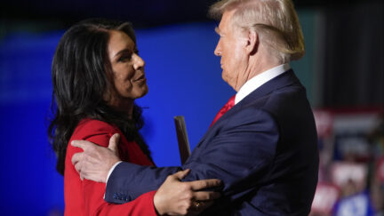 Republican presidential nominee former President Donald Trump hugs former Democratic Rep. Tulsi Gabbard during a campaign rally at Greensboro Coliseum, Tuesday, Oct. 22, 2024, in Greensboro, N.C.