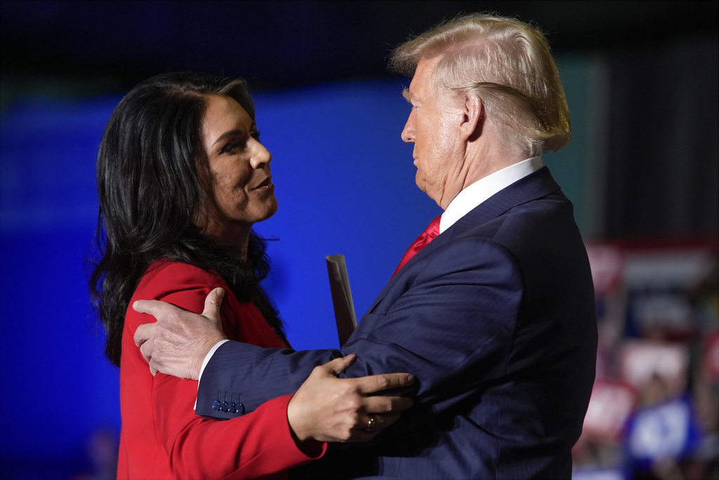 Republican presidential nominee former President Donald Trump hugs former Democratic Rep. Tulsi Gabbard during a campaign rally at Greensboro Coliseum, Tuesday, Oct. 22, 2024, in Greensboro, N.C.