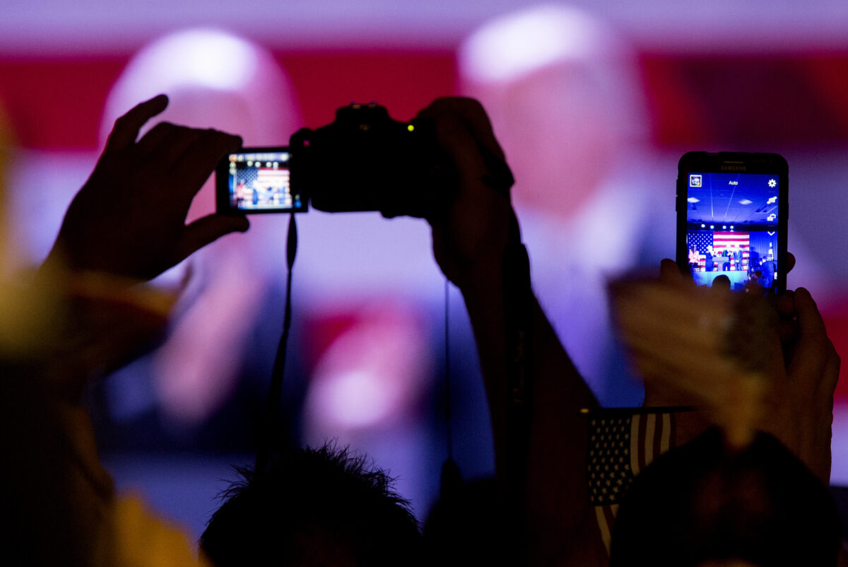 People raise their cameras and phones to take pictures of Vice President Joe Biden.