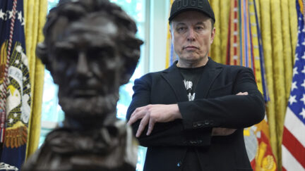 Elon Musk glaring at a bust of Abraham Lincoln as Donald Trump speaks