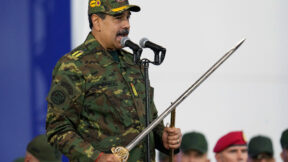 Venezuelan President Nicolas Maduro holds a ceremonial sword during a government-organized civic-military march in Caracas