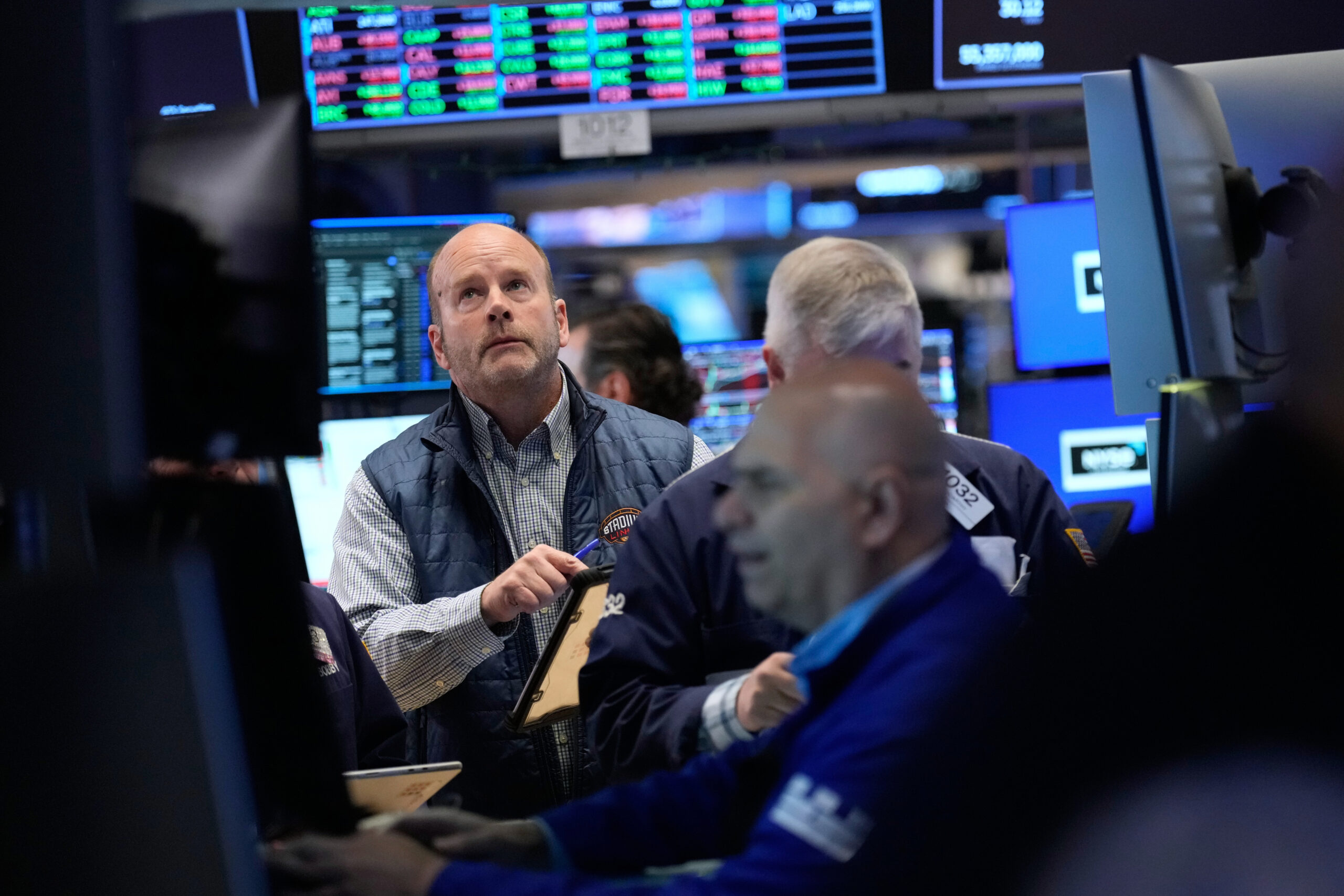 Traders work on the floor at the New York Stock Exchange in New York, Tuesday, April 7, 2026.