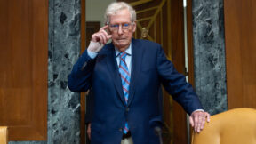 Mitch McConnell gripping the back of a chair