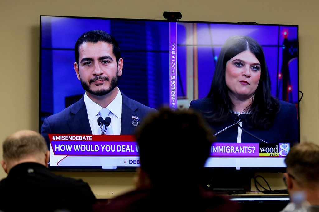 Michigan U.S. Senate candidates, Abdul El-Sayed, left, and Rep. Haley Stevens, D-Mich., are displayed on a television during a debate inside the spin room at WoodTV studios on Tuesday, July 7, 2026, in Grand Rapids, Mich.