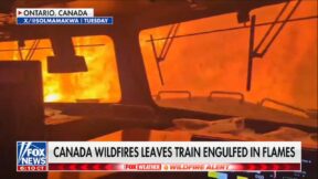 flames surround a canadian train during wildfires as seen from inside the train