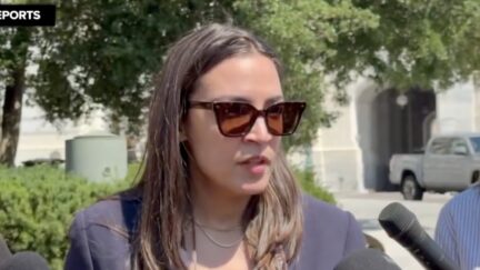 Aoc with sunglasses on speaks to the press outside