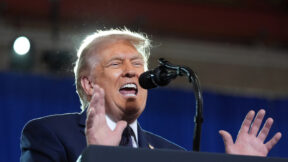 trump at a microphone
