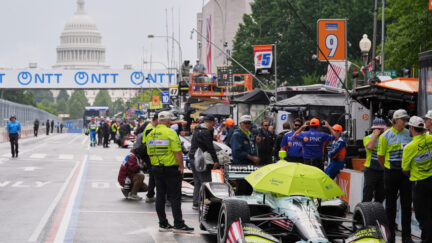 race cars get ready with capitol seen in background