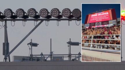 dark lights at doak campbell stadium and fans waving shirts like rally towels